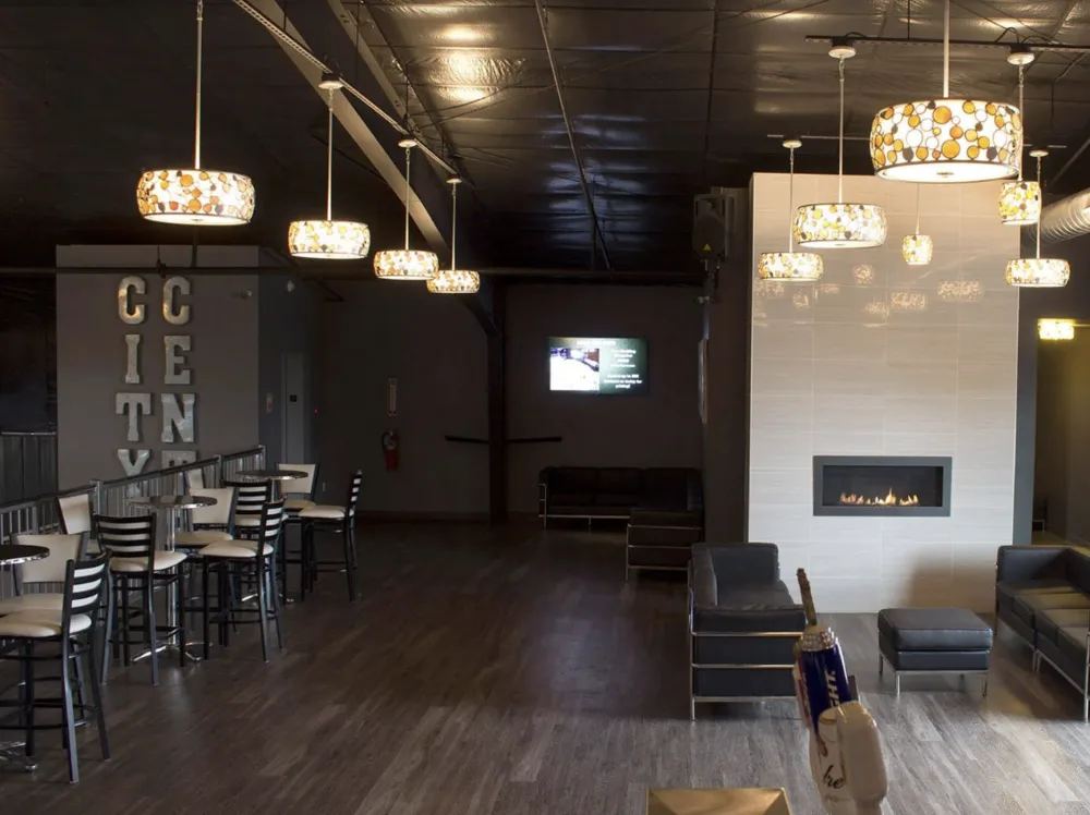The Mezzanine lounge with high-top seating, soft seating, and a fireplace